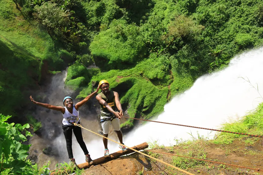 A pair of travellers take on the abseiling challenge to the bottom of the falls. PHOTO BY JONATHAN KAMOGA 3 3 scaled 1 1